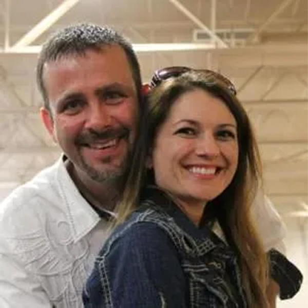 A couple smiling and hugging
