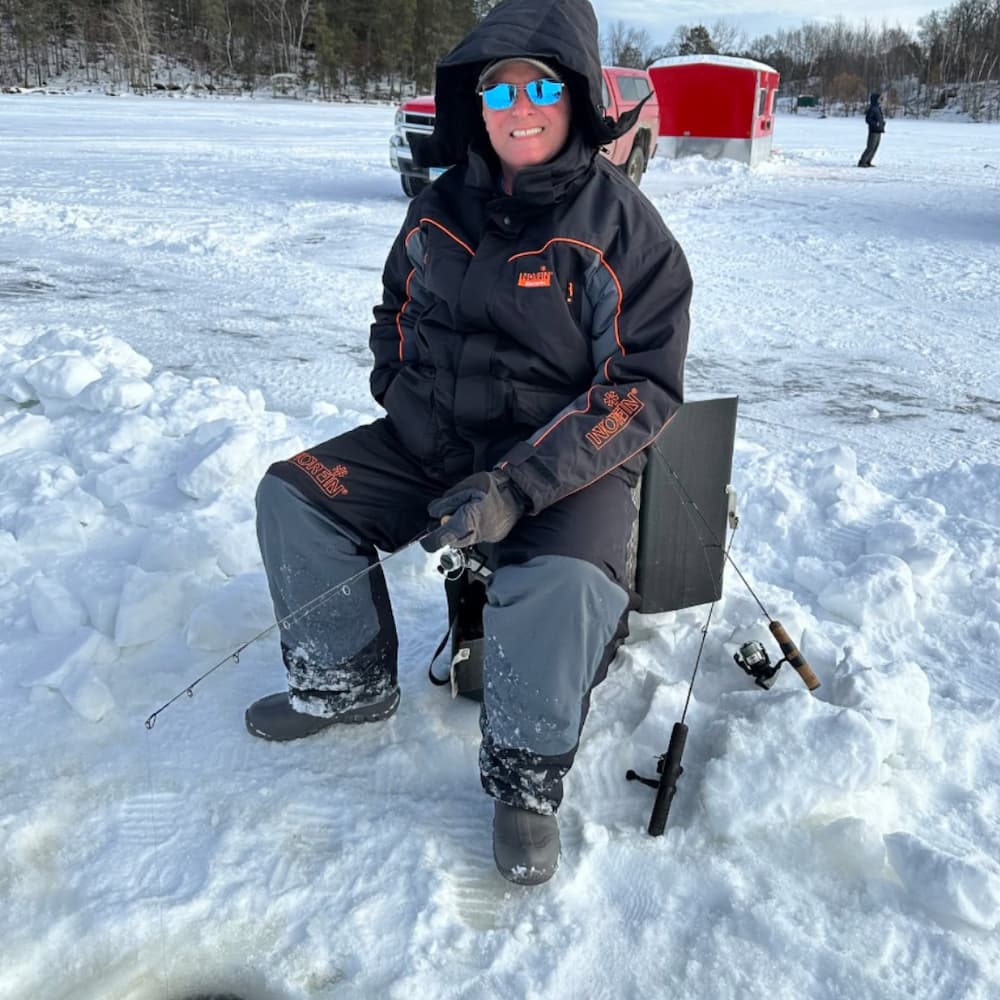 Todd Braschler smiling while ice fishing