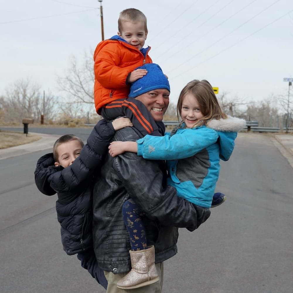 Todd Braschler with children smiling