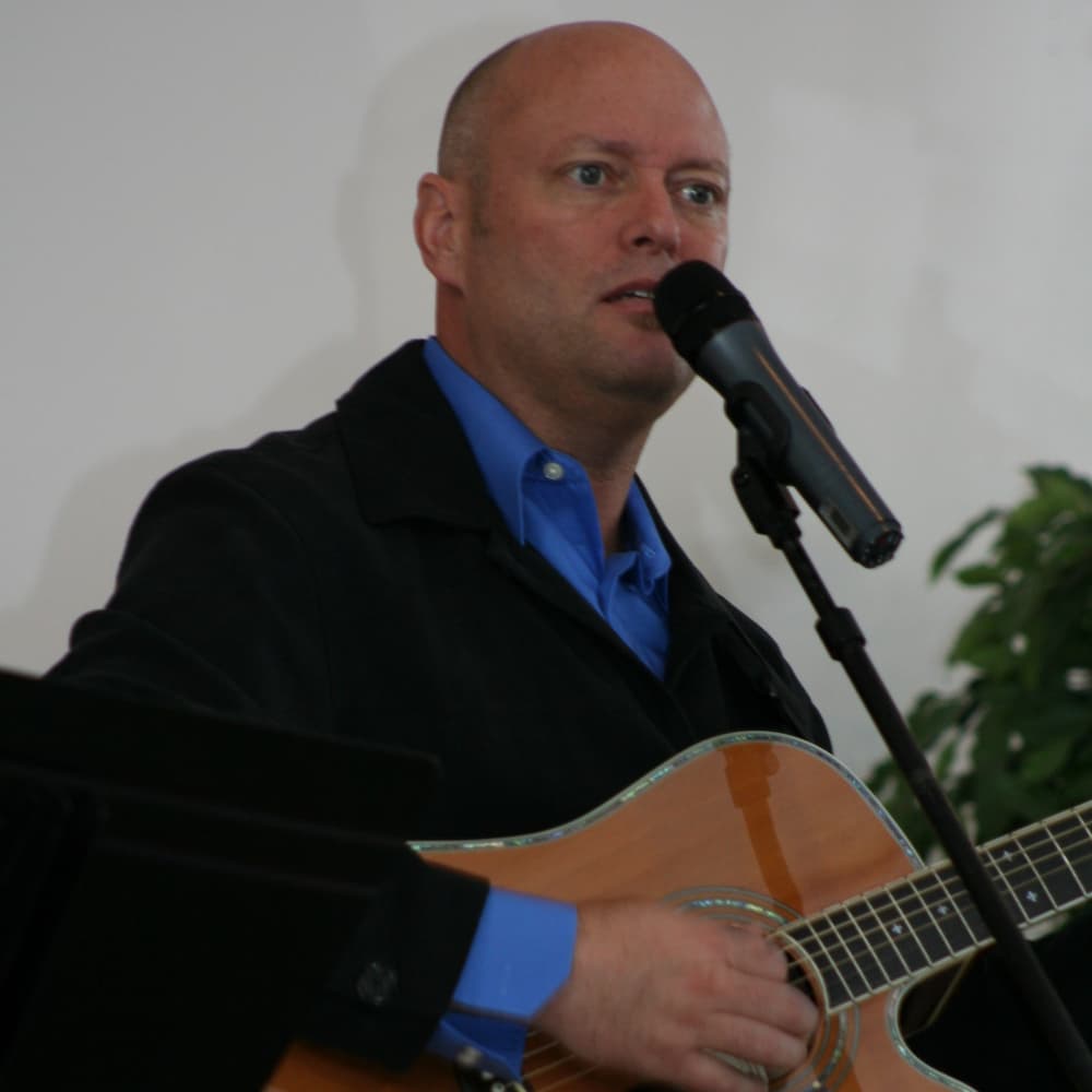 Todd Braschler singing with guitar